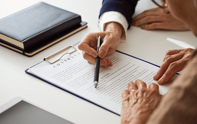 Close-up of contract signing process